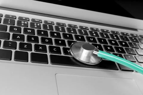 Laptop with stethoscope, closeup view. Computer repair 스톡 사진