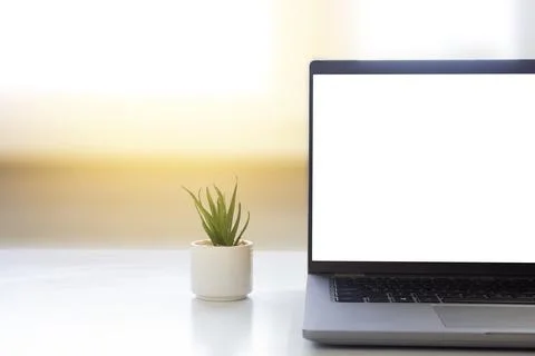 Laptop on the table on the background of the window. Stock Photos