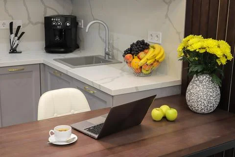 Laptop on table in kitchen interior Foto stock