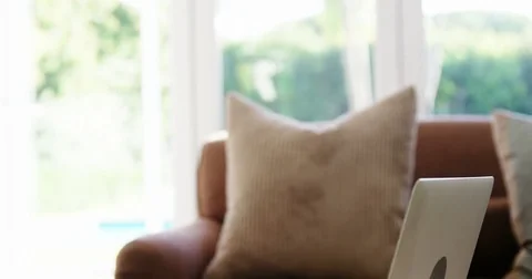 Laptop on table in living room Stock Footage
