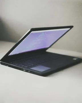 Laptop on the table with programers' code. Work from home 写真素材