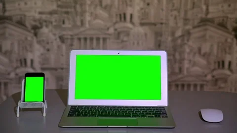 The laptop is on the table, , the smartphone is on the stand, chromakey Stock Footage 70410499