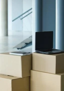 Laptop on top of stack of cardboard boxes 库存照片