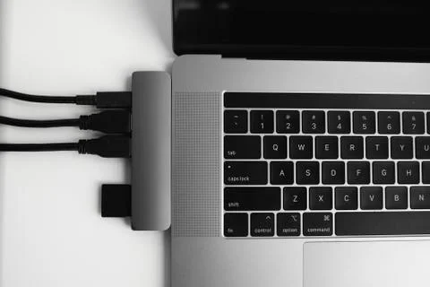 Laptop with USB Type-C adapter with pluged USB cables and SD card. The USB Stock Photos