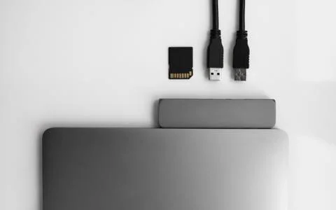Laptop with USB Type-C adapter with pluged USB cables and SD card. The USB Stock Photos