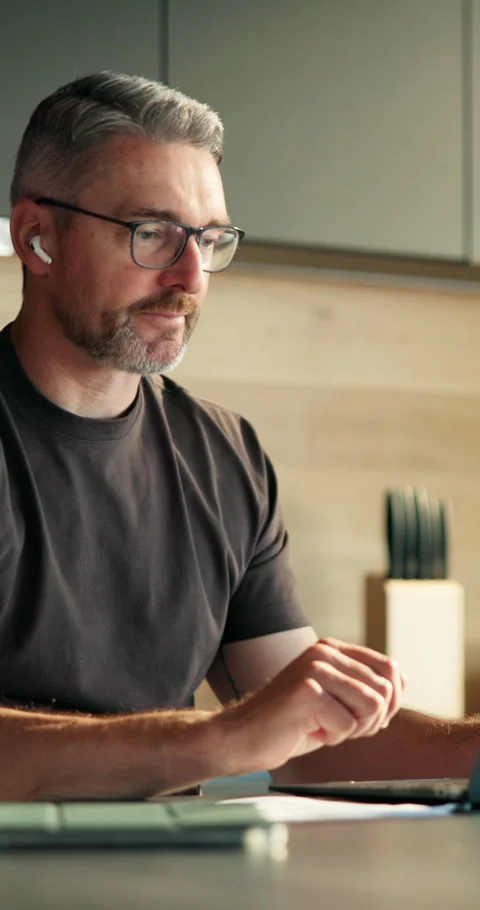 Laptop, video call and wave with man in kitchen, connection and conversation for Stock Footage 337157761