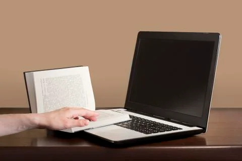 Laptop vs book Stock Photos