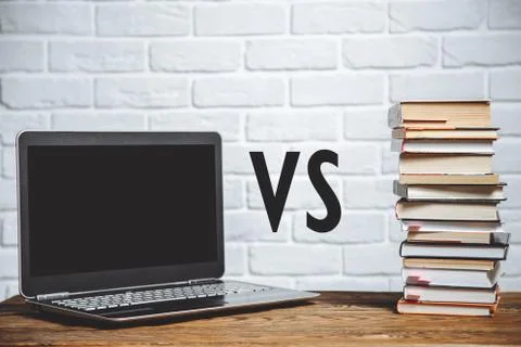Laptop vs stack of books. Education concept Stock Photos