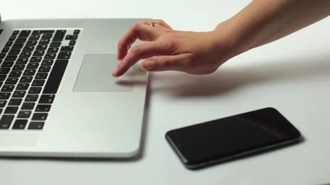 A laptop on a white background, a hand presses the touch panel Stock Footage 245851940
