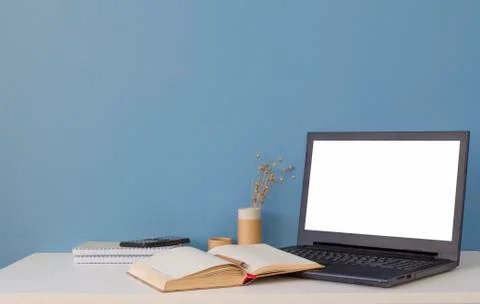 Laptop with white screen on white table. Home office of a creative entrepreneur Stock Photos