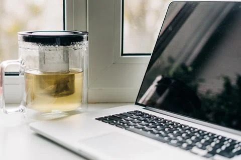 Laptop on window at home. Mockup screen of computer. Remote work or education Stock Photos