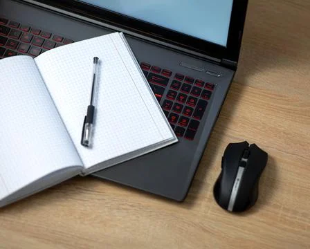 Laptop with wireless mouse, notebook and pen Stock Photos
