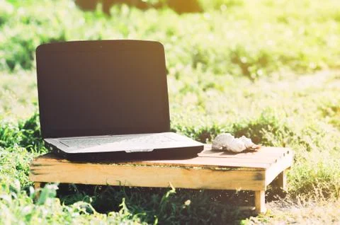 The laptop is on a wooden box Stock Photos