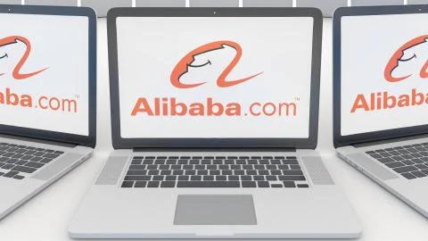 Laptops with Alibaba.com logo on the screen. Computer technology conceptual Illustrazione stock