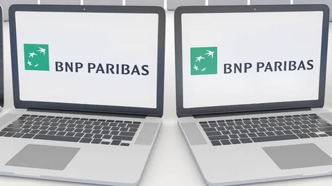 Laptops with BNP Paribas logo on the screen. Computer technology conceptual Stock Footage