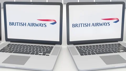Laptops with British Airways logo on the screen. Computer technology conceptual Stock Footage