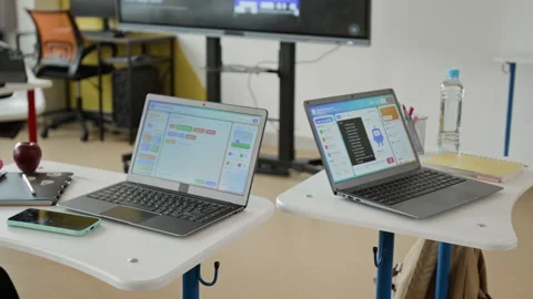 Laptops Displaying Coding Software on Desks in Stem Classroom Vídeo Stock 342811269