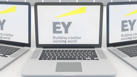 Laptops with Ernst &amp; Young logo on the screen. Computer technology conceptual Illustrazione stock