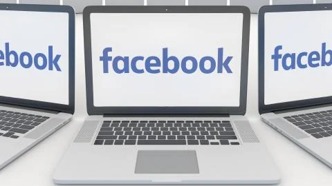 Laptops with Facebook logo on the screen. Computer technology conceptual Stock Illustration