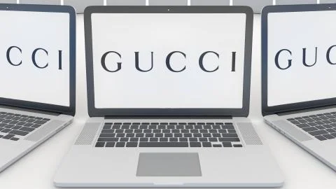 Laptops with Gucci logo on the screen. Computer technology conceptual editorial Stock-Illustration