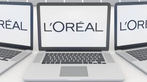 Laptops with L'Oreal logo on the screen. Computer technology conceptual Stock Illustration