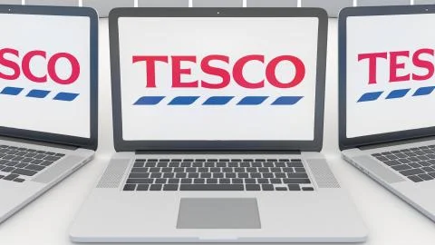 Laptops with Tesco logo on the screen. Computer technology conceptual editorial Illustrazione stock
