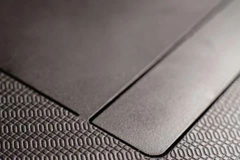 The laptop's touchpad is very close. The buttons are visible. Stock Photos