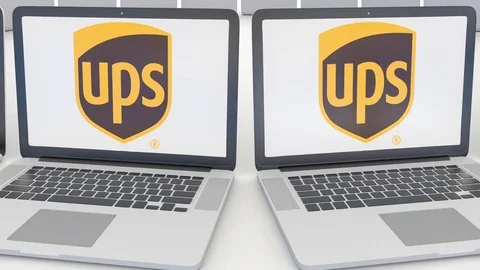 Laptops with United Parcel Service UPS logo on the screen. Computer technology Stock Footage 73116302