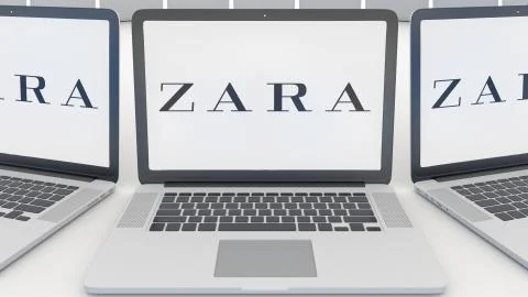 Laptops with Zara logo on the screen. Computer technology conceptual editorial Illustrazione stock