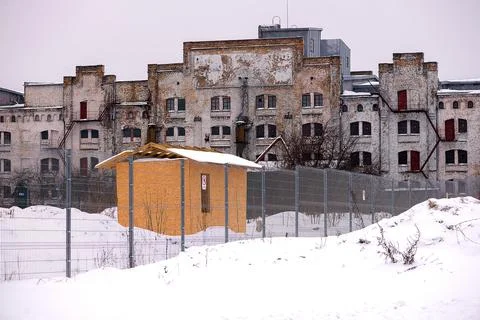 Large abandoned factory facade in winter landscape Stock Photos