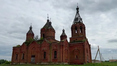 A large, abandoned red brick Orthodox church in a historic Russian village. wide Stock Footage 312472986