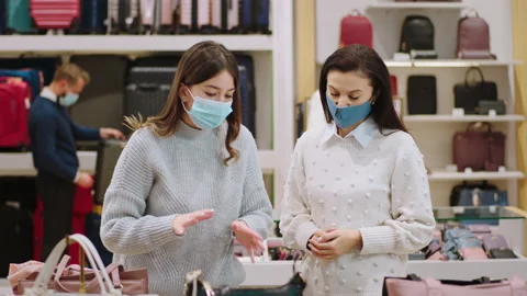 In a large accessories store pretty customer lady with protective mask are Video stock 169869688