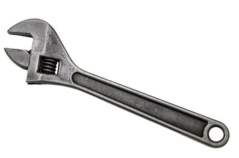 Large adjustable wrench on a white background. Insulated object. Old worn too Stock Photos