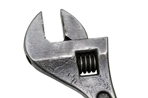 Large adjustable wrench on a white background. Insulated object. Old worn too Stock Photos