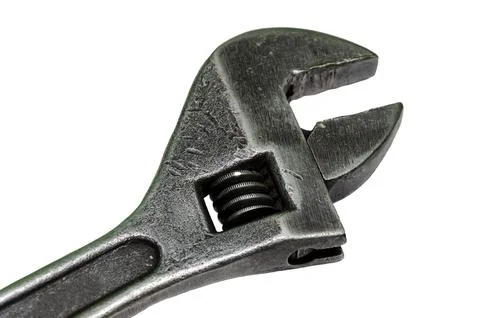 Large adjustable wrench on a white background. Insulated object. Old worn too Stock Photos
