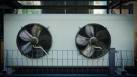 Large air conditioning unit with two fans Stock Photos