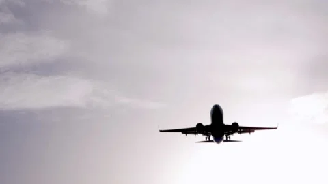 Large aircraft flying under a white sky Video stock 136837355