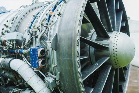 A large aircraft jet engine is shown up close, highlighting various mechanica Stock Photos