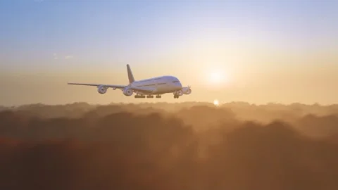 Large aircraft pierce through clouds at sunset Stock Footage 328389938