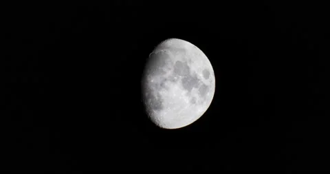 Large almost full moon hanging in the night sky looking over the earth Stock Footage 218412903