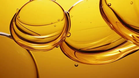 Large amber liquid rings reflect with minimal Video stock 317292654