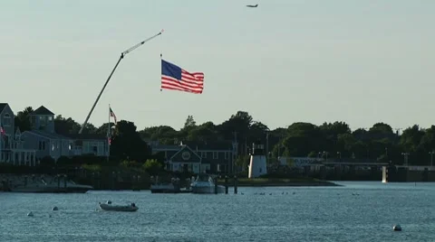 Large American Flag on Crane Over Harbor Video stock 7728330