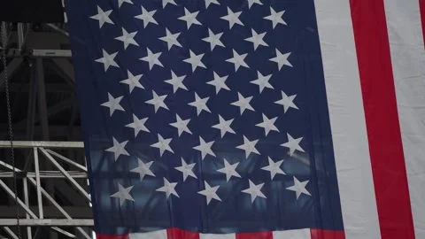 A large American flag hangs in the stadium at the Charlie Kirk memorial service Stock-Footage 345298215