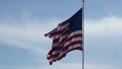Large American Flag Waving in the Wind on Sunny Day Stock Footage 77610222