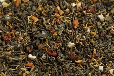 A large amount of dried green tea with the addition of natural flavors and pi Stock Photos