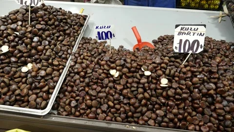 A large amount of raw chestnuts on the chestnut seller's counter, Stock Footage 263643632