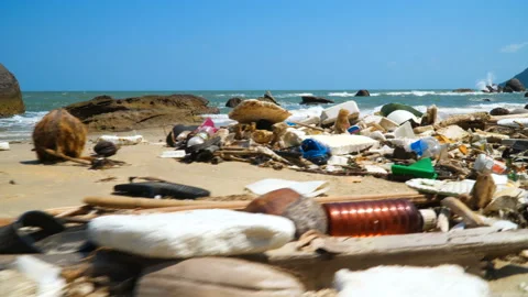 Large amount of trash littering the ocean beach. Plastic Rubbish. Environmental Stock Footage