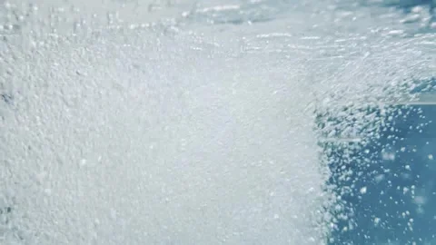 A large amount of white bubbles are floating in the water Stock Footage 282899362