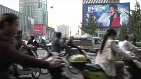 Large amounts of traffic pass by on a Beijing China street Stock Footage 556327