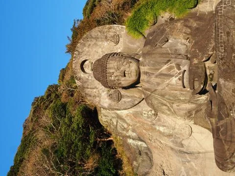 Large ancient Buddha statue on Mount Nokogira in Japan.. Stock Photos